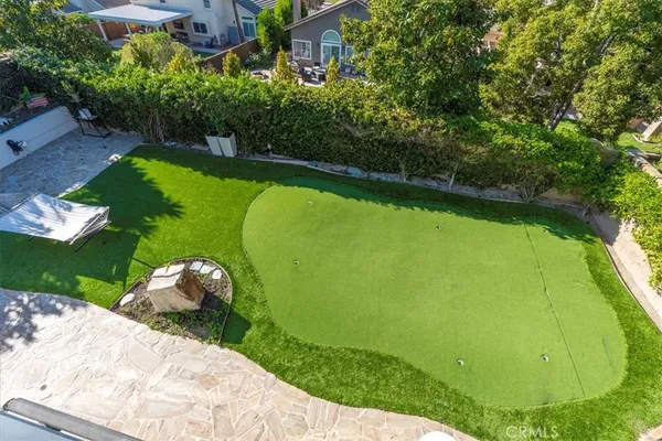 an aerial view of a house with garden space and street view