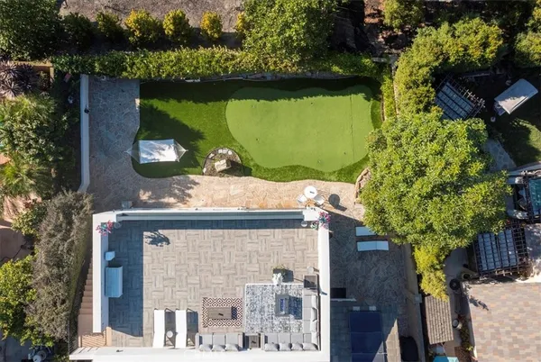 an aerial view of multiple houses with a yard