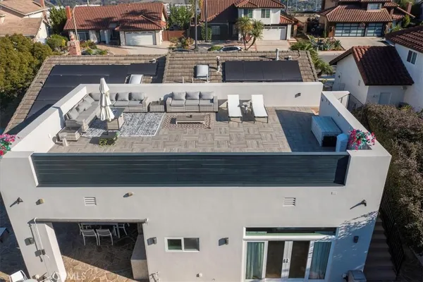 an aerial view of a house with garden space and street view