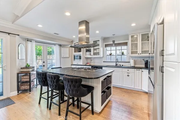 a kitchen with a table chairs refrigerator and microwave