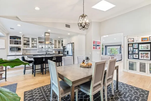 a kitchen with stainless steel appliances a stove a table and chairs