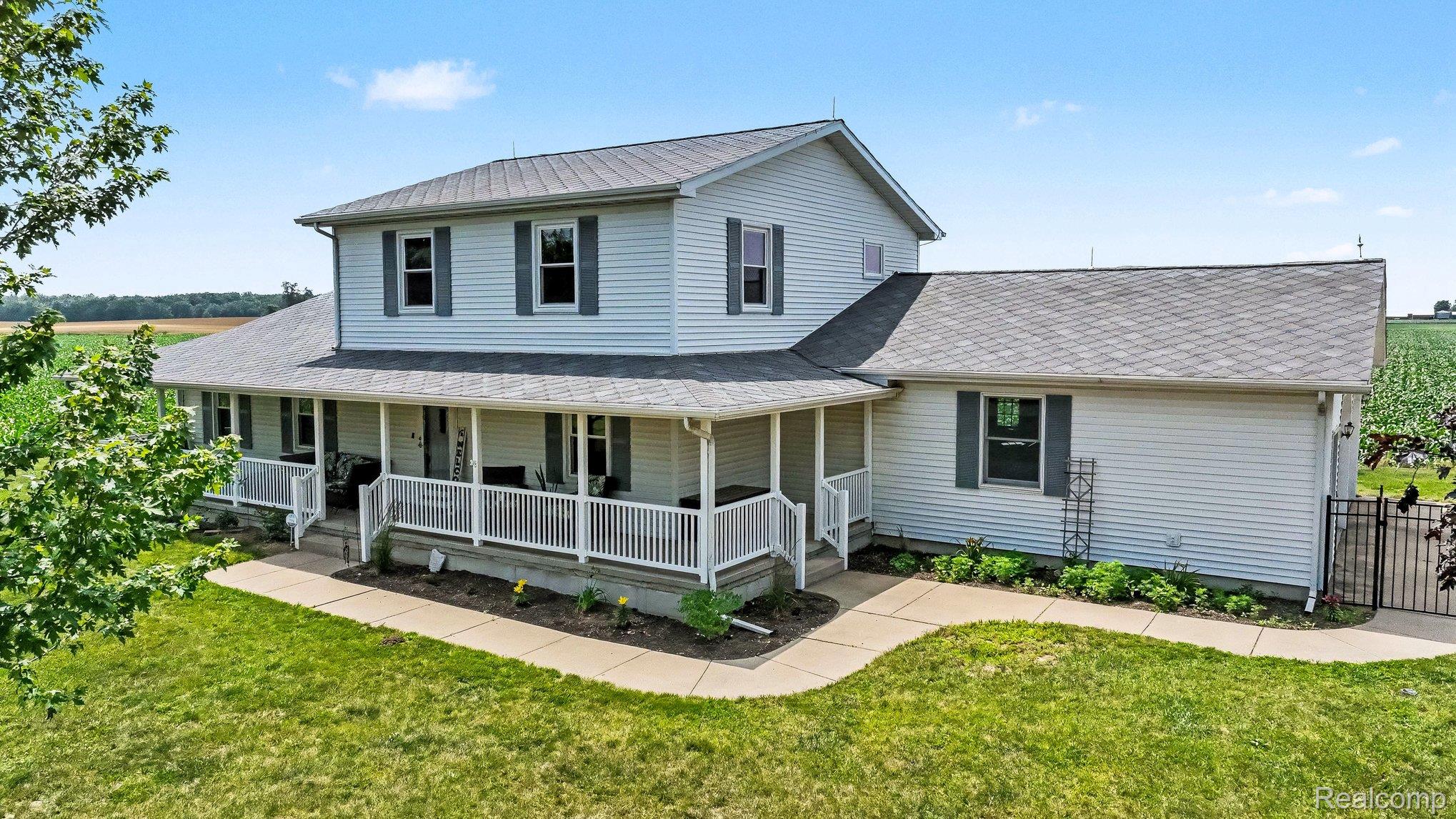 996 Arbogast Road Union City, MI 49094 - Photo 1 of 34 Two-story residence featuring light-colored siding and a covered front porch with white railings