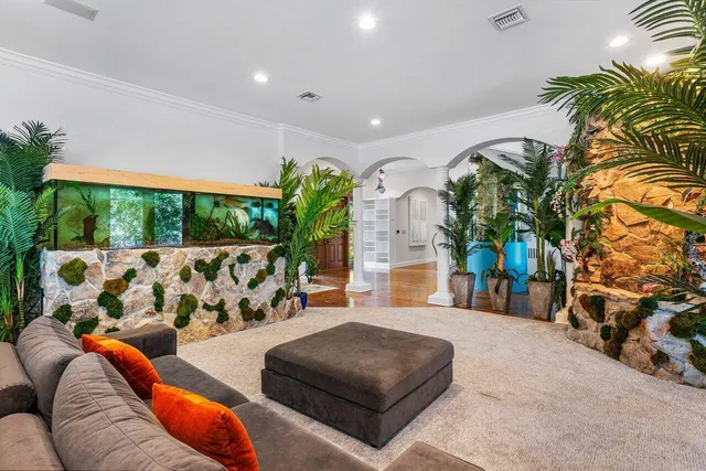a living room with furniture and a potted plant