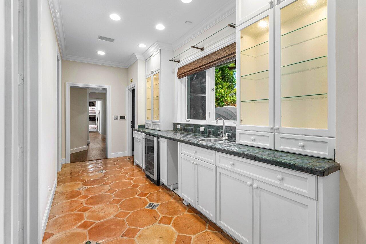 963 Eve Street Delray Beach, FL 33483 - Photo 22 of 83 a large kitchen with granite countertop a sink and a window