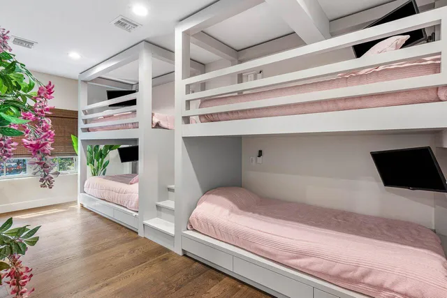 a bed sitting in a room next to a window