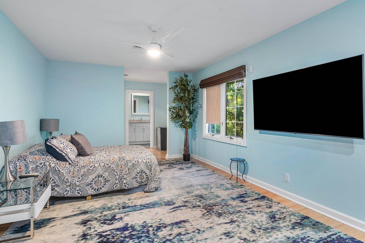 963 Eve Street Delray Beach, FL 33483 - Photo 31 of 83 a bedroom with a bed and a flat screen tv