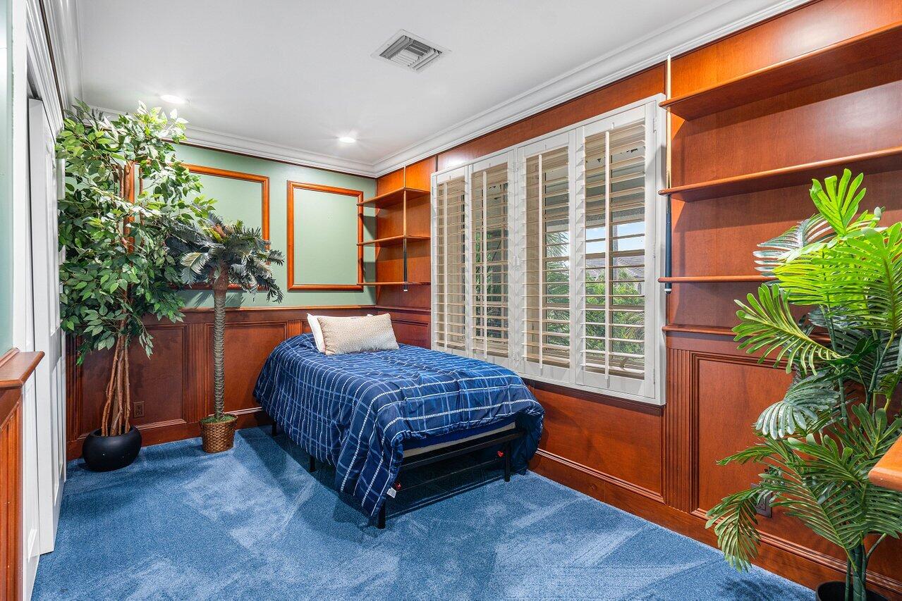 963 Eve Street Delray Beach, FL 33483 - Photo 43 of 83 a bed sitting in a room next to a window