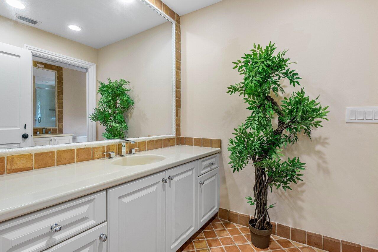 963 Eve Street Delray Beach, FL 33483 - Photo 47 of 83 a bathroom with a sink and a mirror