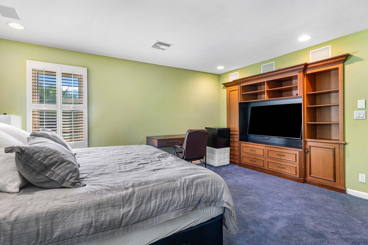 963 Eve Street Delray Beach, FL 33483 - Photo 51 of 83 a bedroom with a bed and a television in it