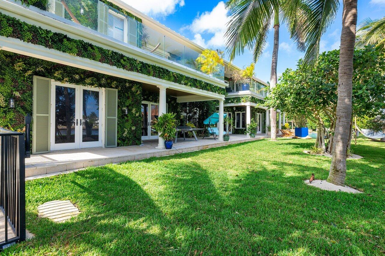 963 Eve Street Delray Beach, FL 33483 - Photo 70 of 83 front view of a building with a yard
