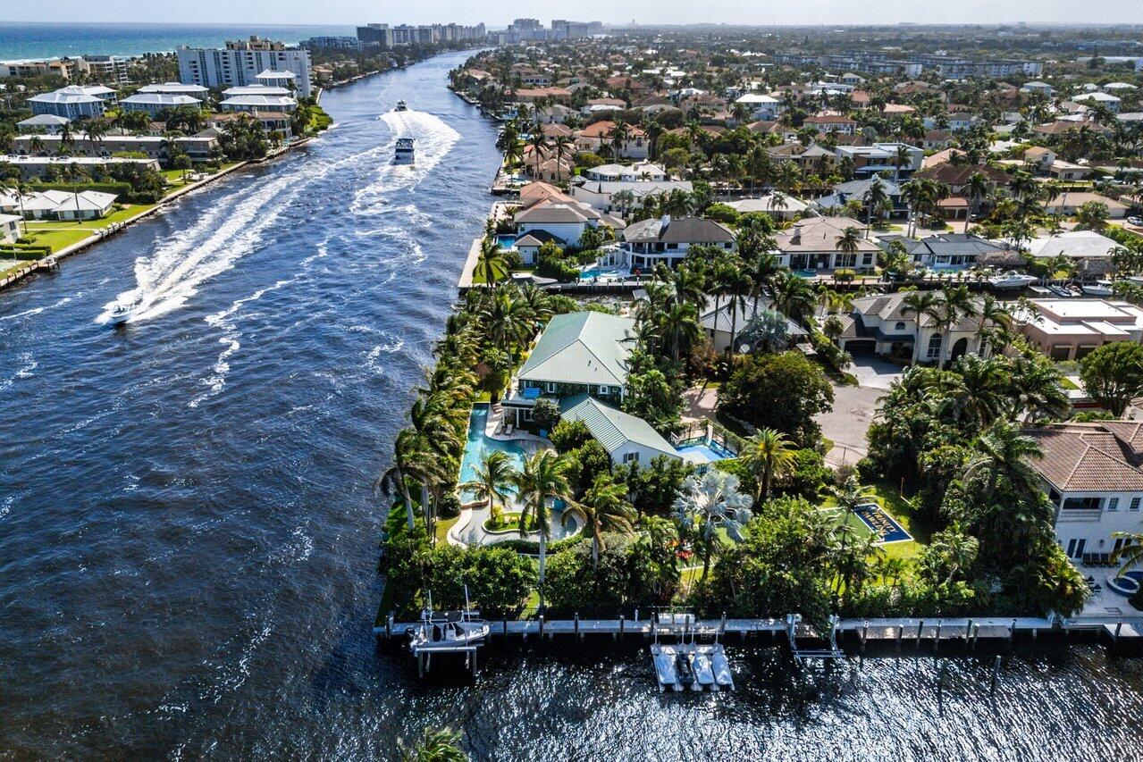 963 Eve Street Delray Beach, FL 33483 - Photo 83 of 83 an aerial view of a house with a yard and lake view in back