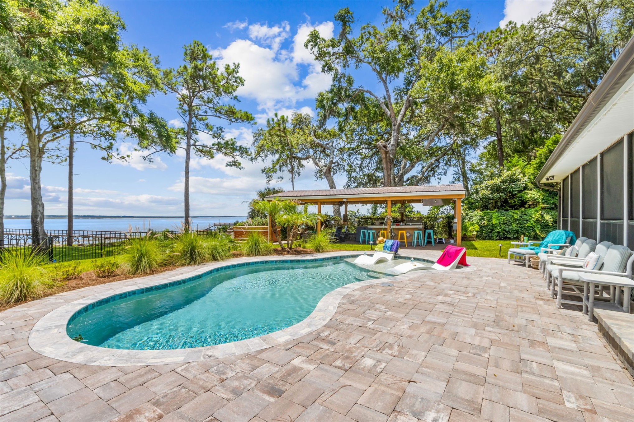 95210 Cook Road Fernandina Beach, FL 32034 - Photo 3 of 70 a view of a swimming pool with lawn chairs under an umbrella