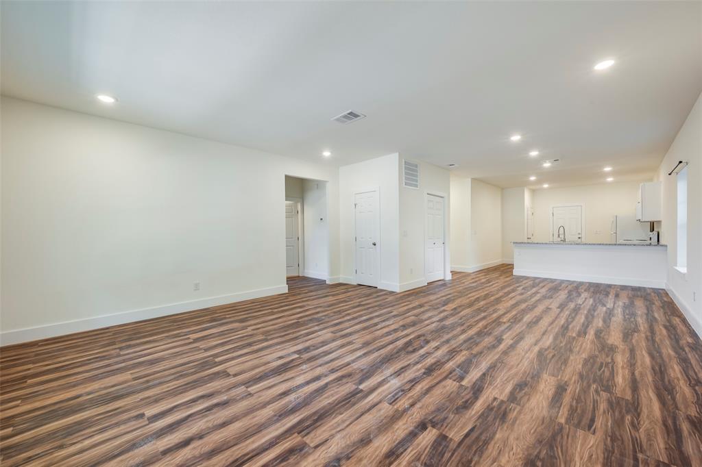 3523 Herrling Street Dallas, TX 75210 - Photo 3 of 14 Unfurnished living room featuring dark wood finished floors and recessed lighting