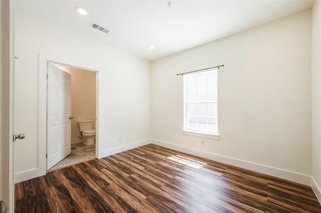 3523 Herrling Street Dallas, TX 75210 - Photo 10 of 14 Unfurnished bedroom with dark wood-type flooring, recessed lighting, and ensuite bath