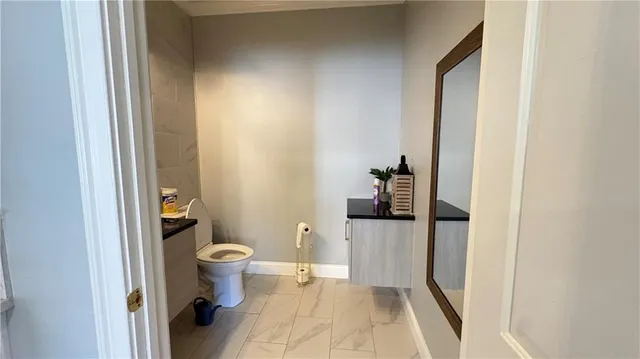 a bathroom with a toilet and a shower