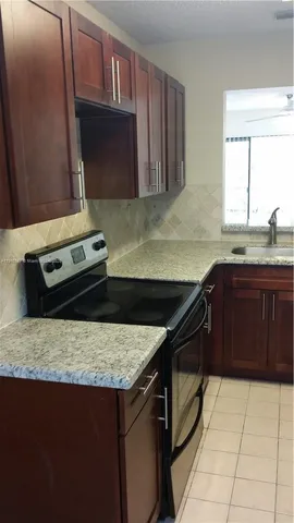 a kitchen with a stove a sink and a microwave