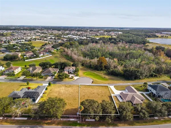 an aerial view of a residential houses with outdoor space and swimming pool