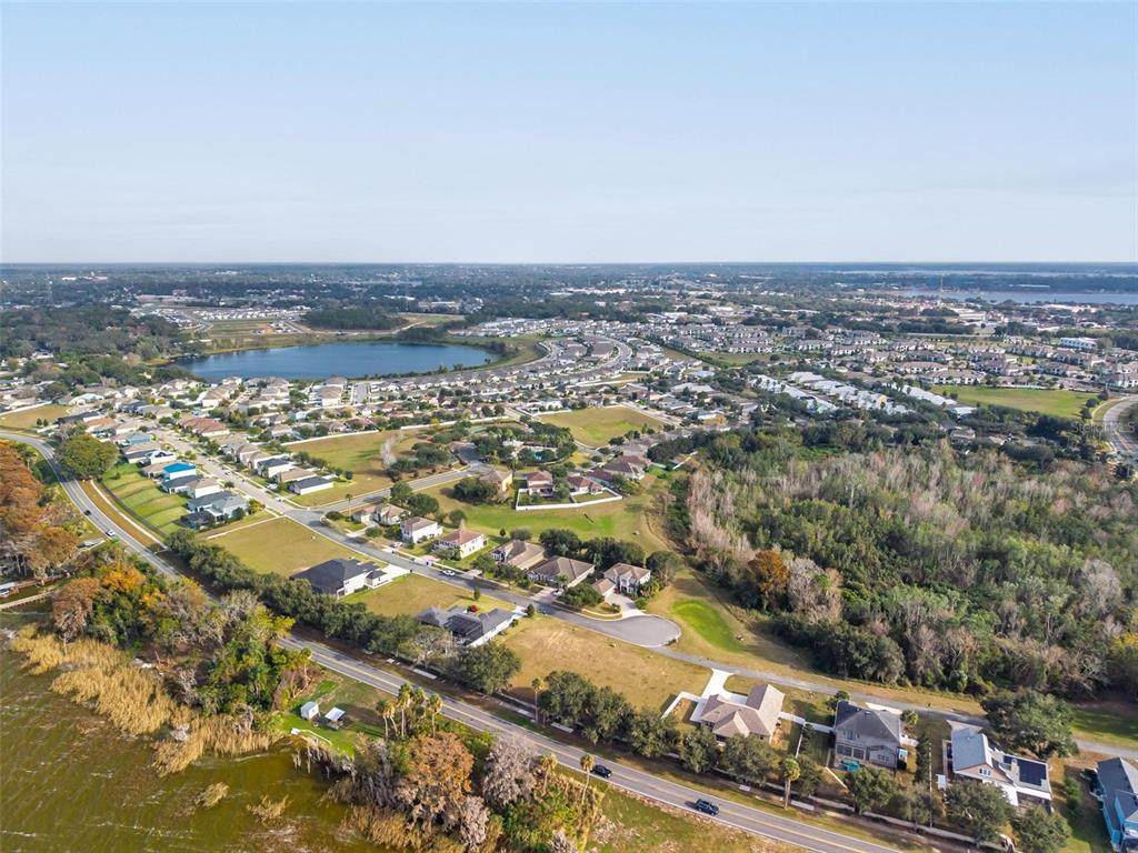 3225 Landing View Tavares, FL 32778 - Photo 27 of 31 an aerial view of residential building and car parked