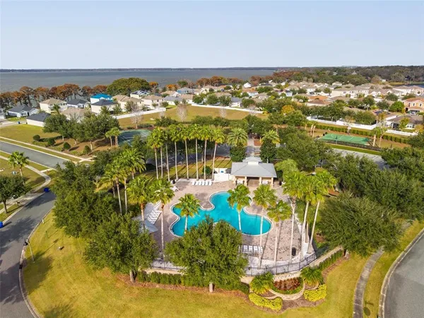 an aerial view of a house with a yard and greenery