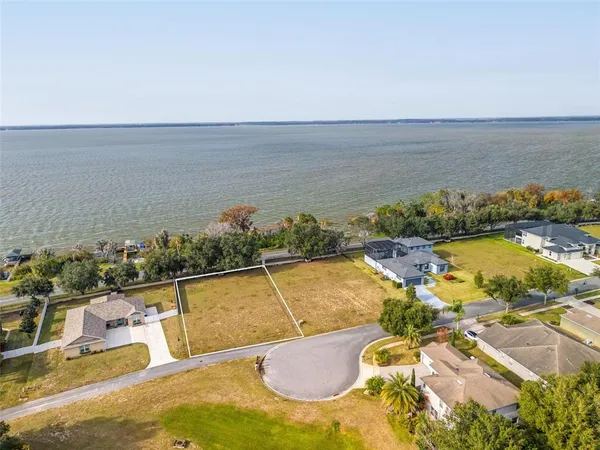 an aerial view of a house with a swimming pool and outdoor seating