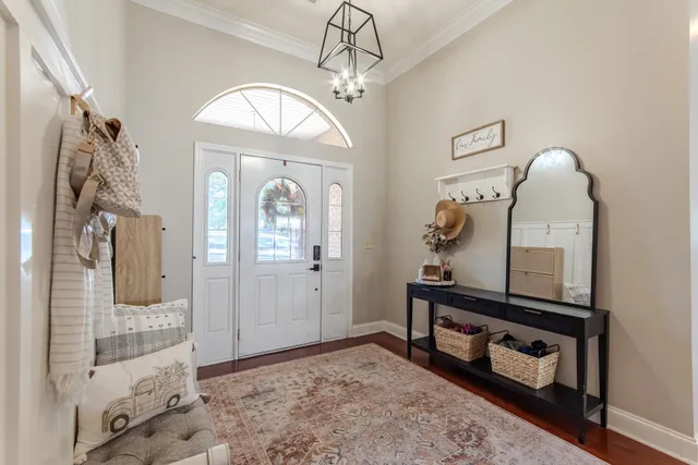 a view of a hallway with entryway windows and wooden floor