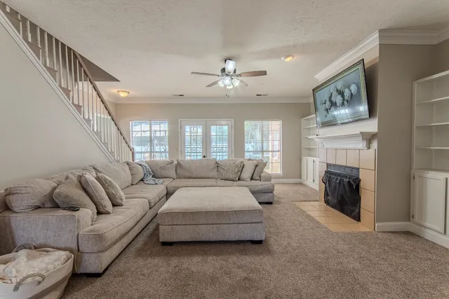 a living room with furniture and a fireplace