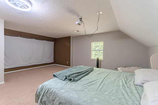 a bedroom with a bed and window