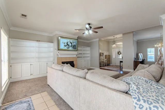 a living room with furniture and a chandelier