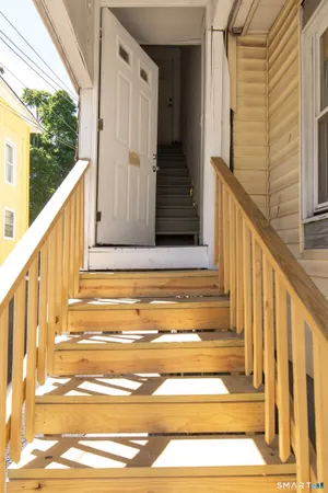 a view of balcony with wooden floor and door