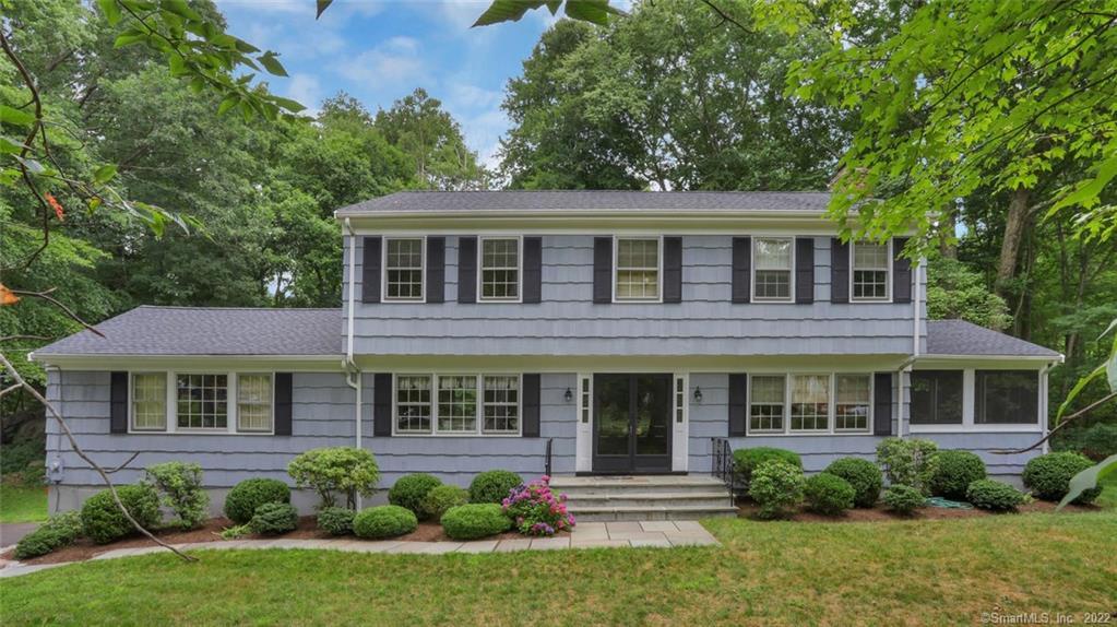 326 Dundee Road Stamford, CT 06903 - Photo 1 of 1 a front view of a house with porch and garden