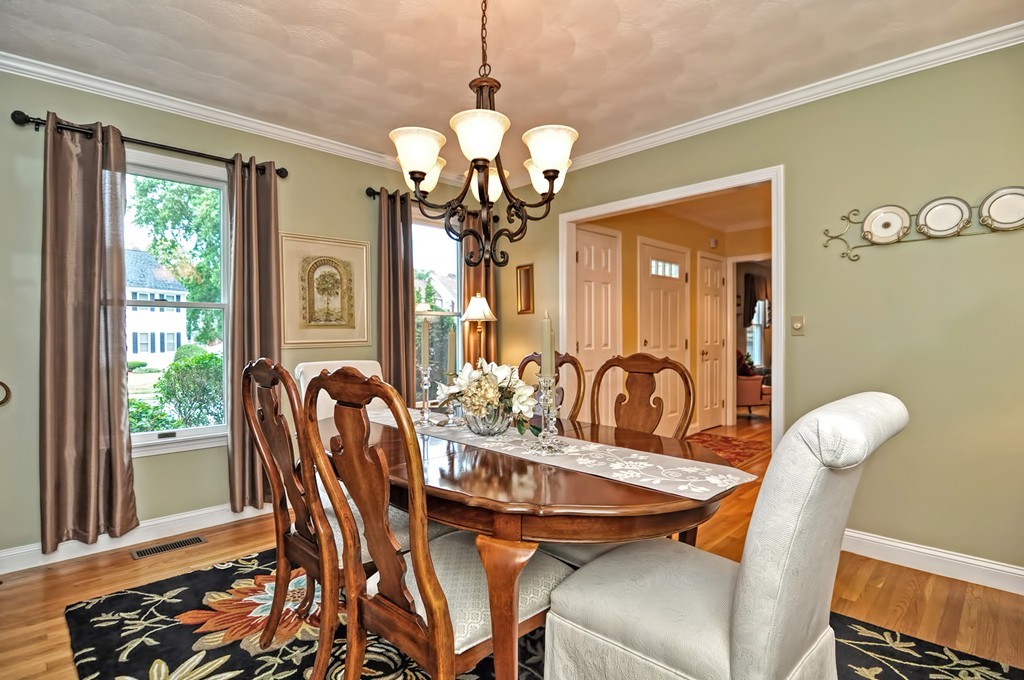 4 Nottingham Way Stoneham, MA 02180 - Photo 6 of 30 a dining room with wooden floor a chandelier a wooden table and chairs