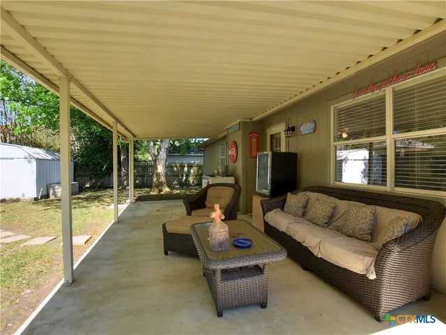 a outdoor living space with patio furniture and garden view