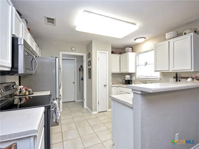 a kitchen with a sink cabinets and window