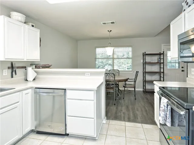 a kitchen with a sink cabinets and window