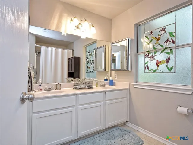 a bathroom with a double vanity sink mirror and double