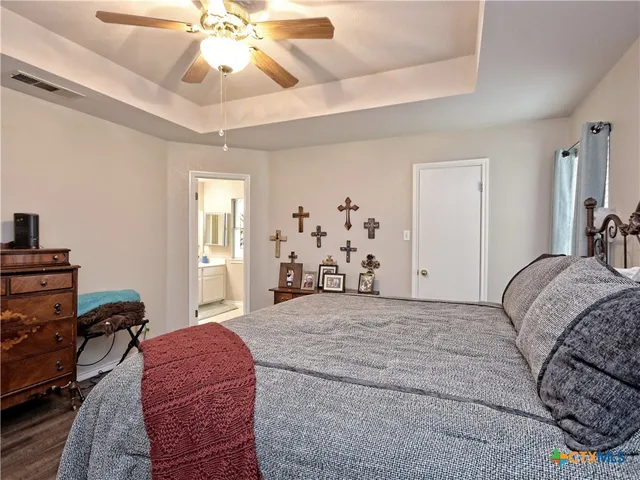 a spacious bedroom with a bed and ceiling fan