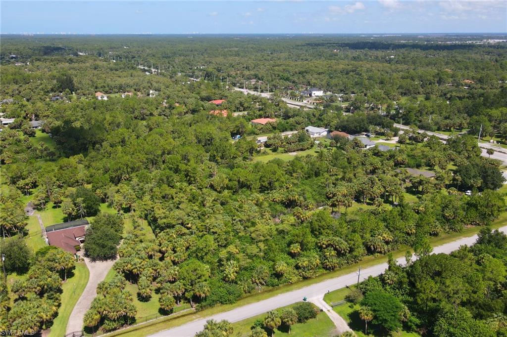 121 15th Street Southwest Naples, FL 34117 - Photo 7 of 8 an aerial view of residential houses with outdoor space and trees