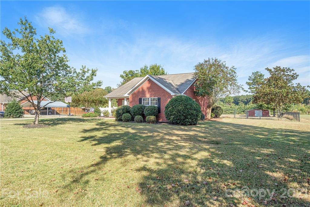 6107 Stack Road Monroe, NC 28112 - Photo 2 of 24 a view of a house with a yard and palm trees
