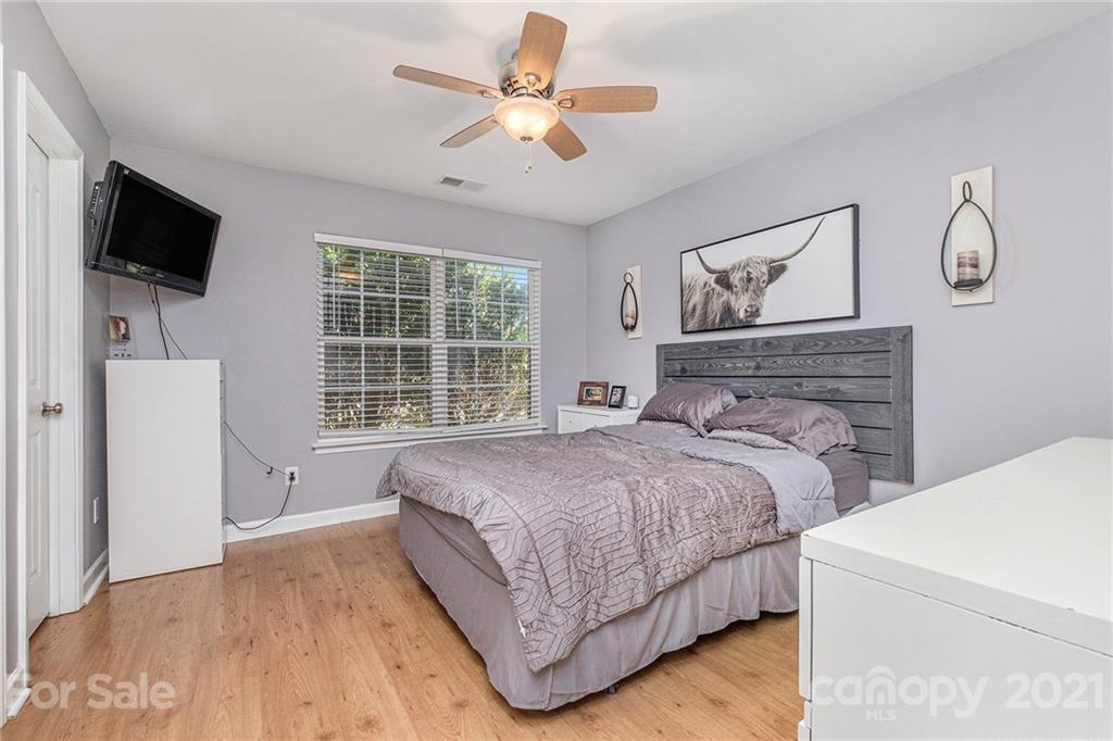 6107 Stack Road Monroe, NC 28112 - Photo 15 of 24 a bedroom with a large bed and a flat tv screen on dresser