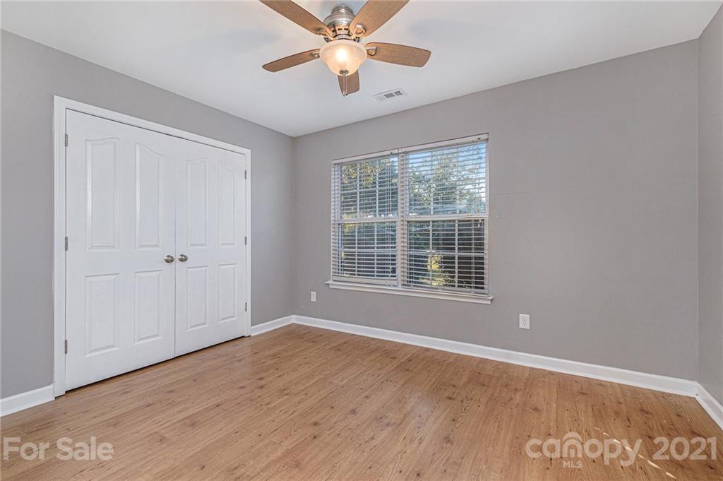 6107 Stack Road Monroe, NC 28112 - Photo 17 of 24 a view of an empty room with wooden floor and a window