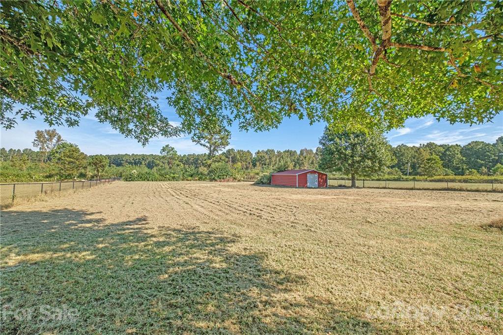 6107 Stack Road Monroe, NC 28112 - Photo 20 of 24 a view of a lake with a yard