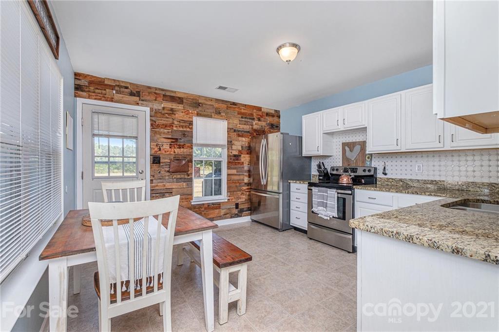 6107 Stack Road Monroe, NC 28112 - Photo 5 of 24 a kitchen with granite countertop lots of counter top space and stainless steel appliances