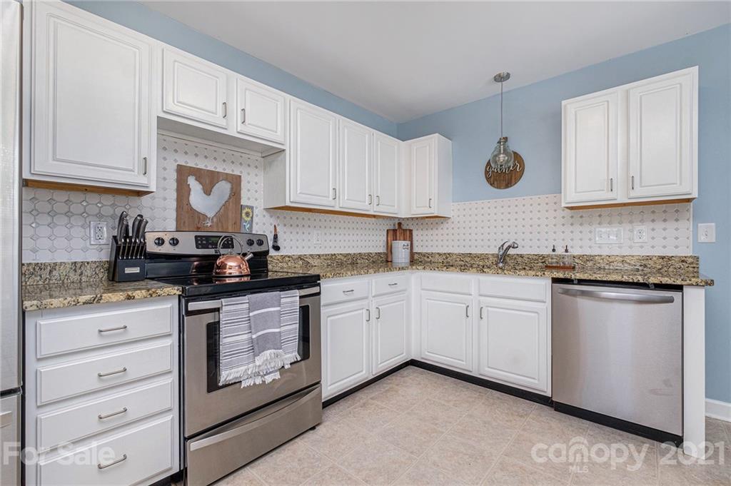 6107 Stack Road Monroe, NC 28112 - Photo 7 of 24 a kitchen with granite countertop white cabinets and white appliances