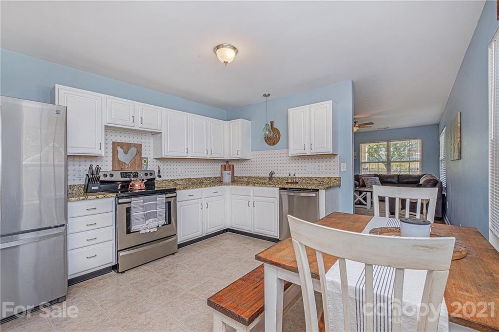 6107 Stack Road Monroe, NC 28112 - Photo 8 of 24 a kitchen with white cabinets and stainless steel appliances