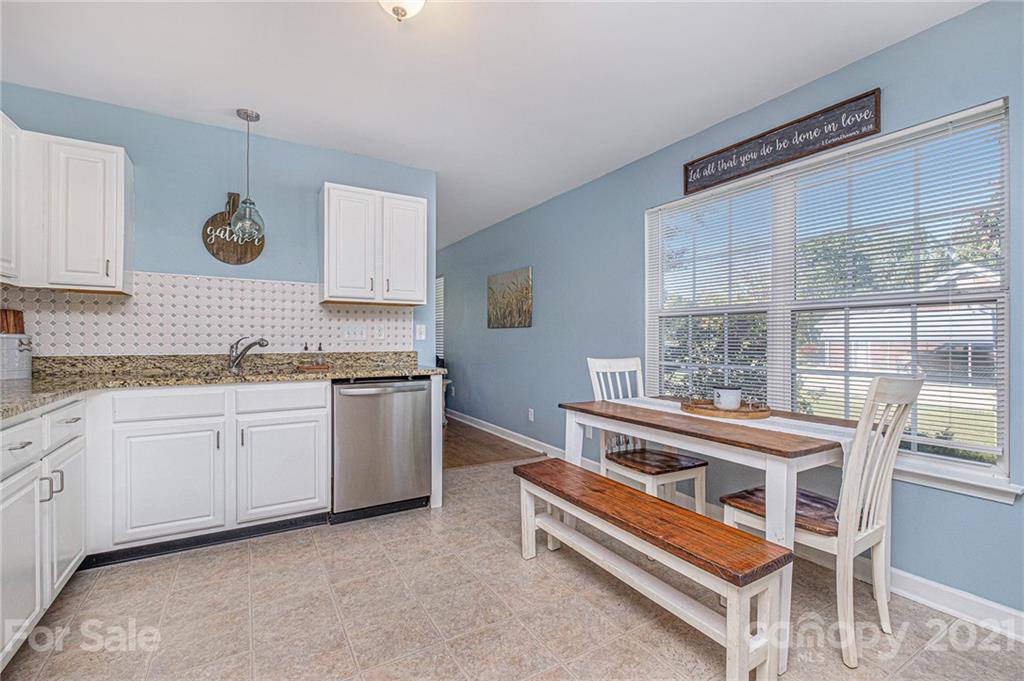 6107 Stack Road Monroe, NC 28112 - Photo 9 of 24 a kitchen with granite countertop a stove a sink and a microwave
