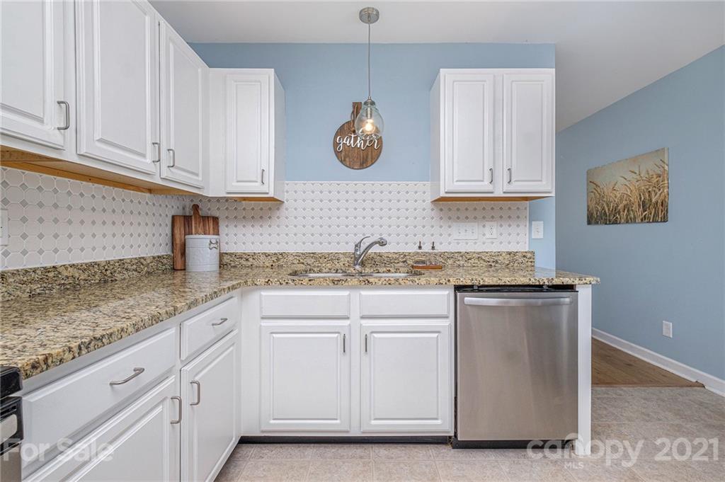 6107 Stack Road Monroe, NC 28112 - Photo 10 of 24 a kitchen with granite countertop white cabinets and a sink