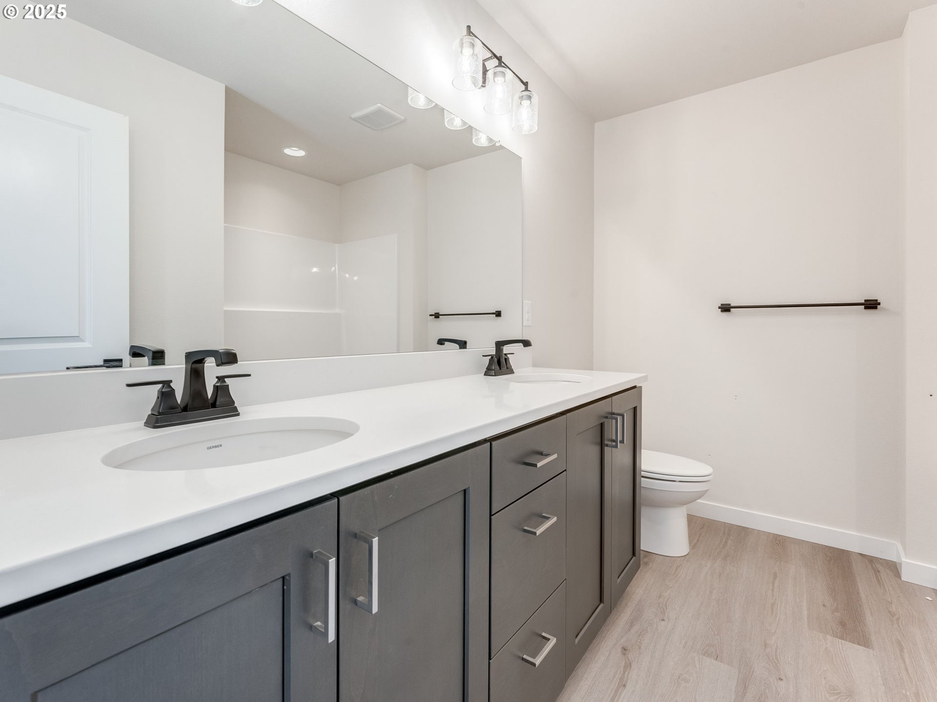 744 Northwest 178th Street Ridgefield, WA 98642 - Photo 15 of 25 a bathroom with a double vanity sink and a toilet