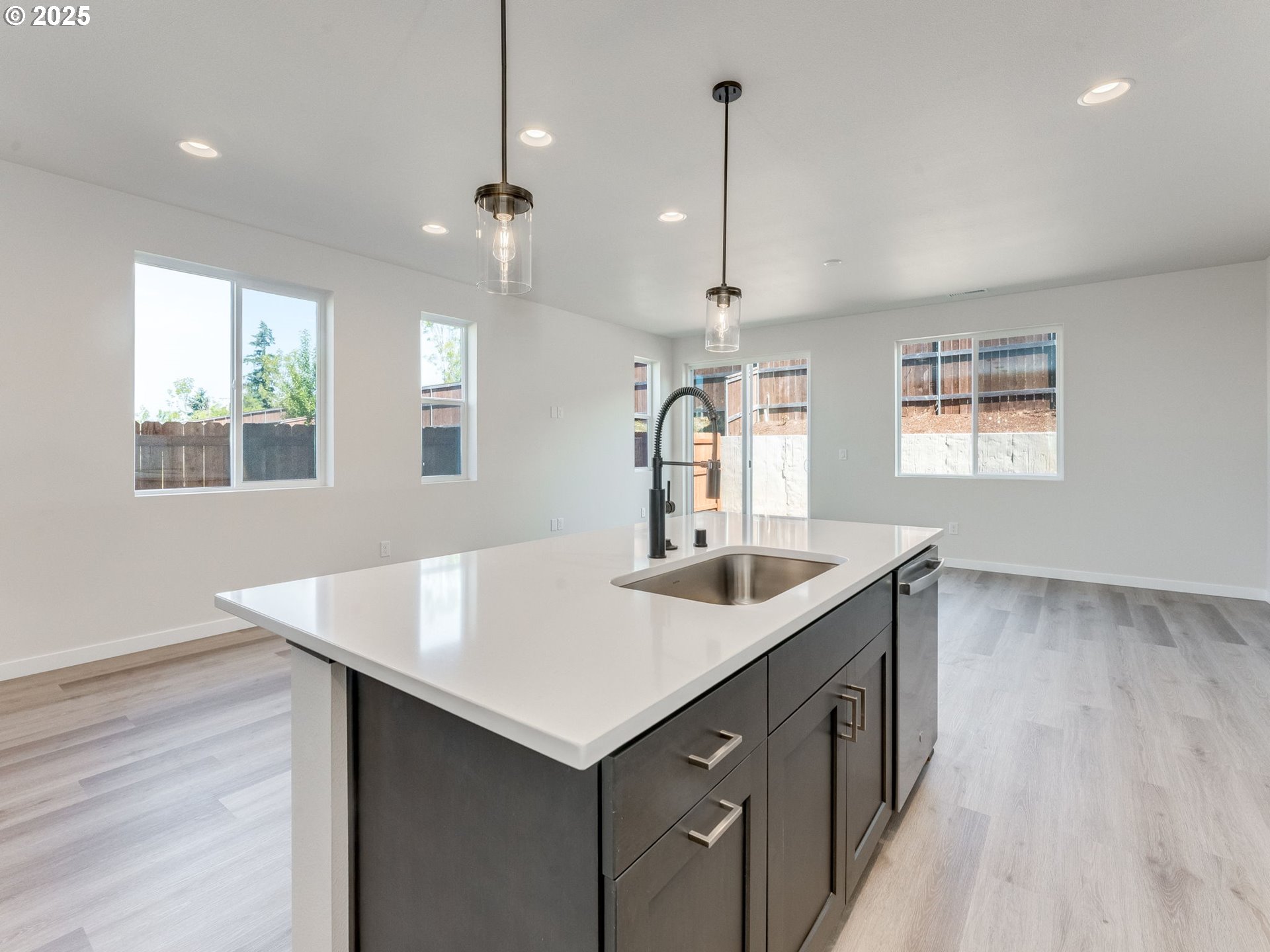 744 Northwest 178th Street Ridgefield, WA 98642 - Photo 3 of 25 a kitchen with a sink a counter space and wooden floor
