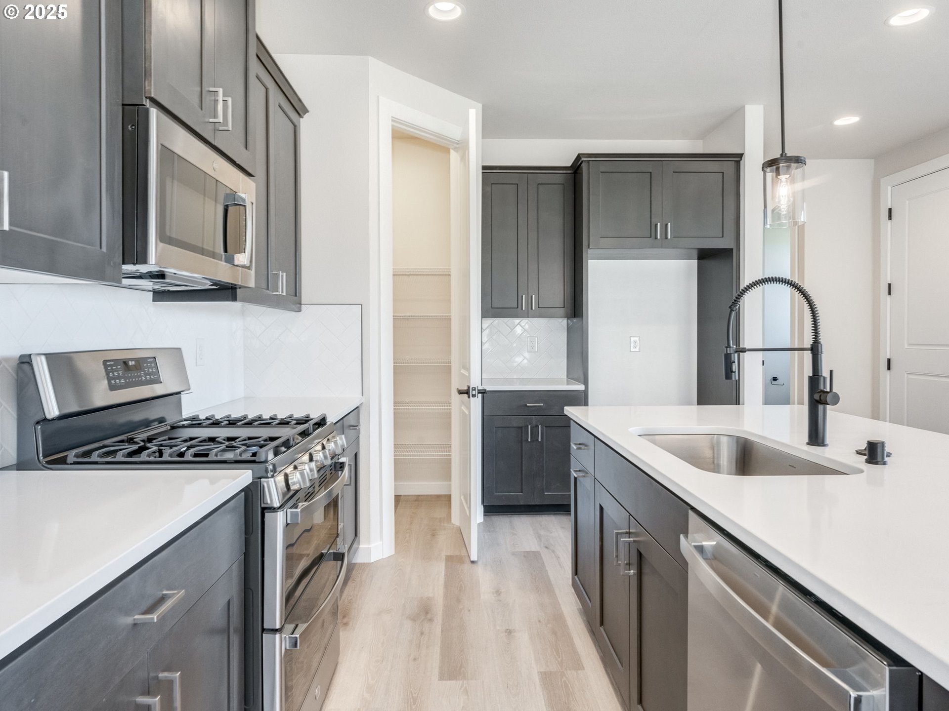 744 Northwest 178th Street Ridgefield, WA 98642 - Photo 4 of 25 a kitchen with stainless steel appliances granite countertop a sink stove and cabinets
