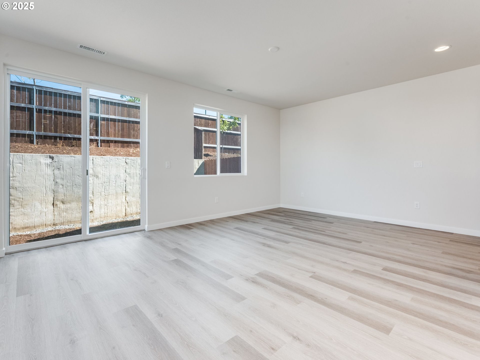 744 Northwest 178th Street Ridgefield, WA 98642 - Photo 6 of 25 an empty room with wooden floor and windows